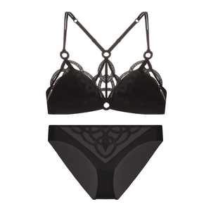 Flat lay of black lace lingerie set with geometric embroidery and multi-strap design