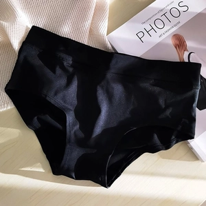 Detail of black high-waisted seamless panties showing silky texture and smooth edge finish