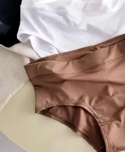Close-up of high-waist seamless brown panties with breathable silky fabric texture