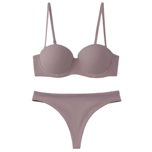 Detail view of seamless light purple lingerie set with 1/2 cup bra and thong on white base