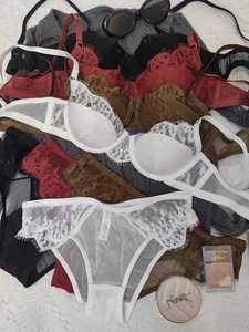 Detailed flat lay of floral lace lingerie sets in white, burgundy, brown, and black