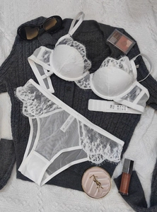 Flat lay of white embroidered lace lingerie set with 75B bra and matching M briefs