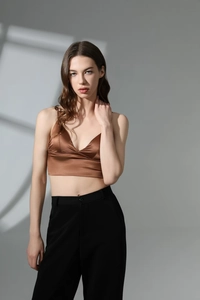 Detail of caramel satin triangle bralette with thin straps and deep V-neckline
