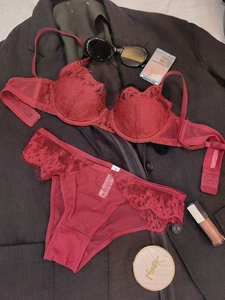 Detailed macro view of burgundy lace bra and panties set with size M wash label