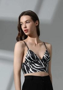 Detail of zebra print bralette showing thin shoulder straps and satin texture V-neck