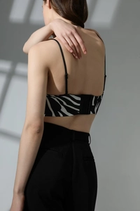 Detail of zebra pattern bra featuring thin straps and back hook-and-eye closure