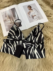 Detail of zebra print bra with adjustable thin straps and multi-row back hook closure