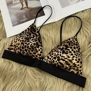 Leopard print triangle bralette with thin straps and elastic band on plush background