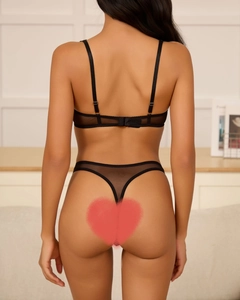 Detail of sheer black lace lingerie set with thin straps and hook-eye back closure