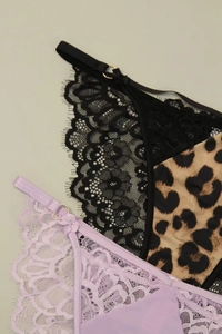 Detailed macro view of lace embroidery and leopard print panties with gold hardware