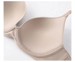 Detail of breathable seamless nude bra fabric showing micro-porous texture and stitching