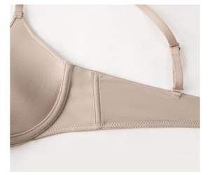 Detail view of seamless beige bra wings and adjustable strap for side support