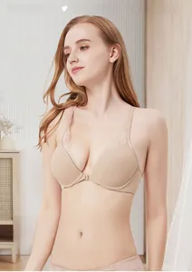 Detailed view of the convenient front closure and delicate lace trim on the beige bra
