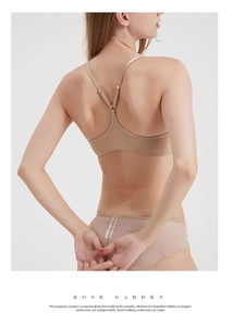 Detail of nude seamless bra with Y-shaped cross back design and delicate lace trim