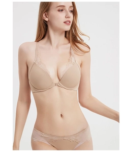 Detailed close-up of beige front-closure bra with delicate lace trim and smooth fabric