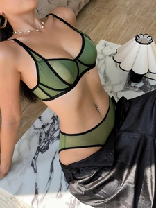 Detail of dark green sheer mesh lingerie set with black piping and French style triangle cups