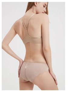 Detailed back view of a beige lace bra set featuring a Y-shaped cross strap design
