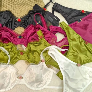 Lace lingerie set with satin fabric and floral details in multiple vibrant colors