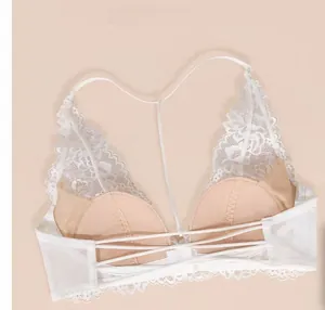 Detailed view of white French lace bra with intricate criss-cross back strap design