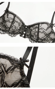 Detail view of black floral lace bra featuring eyelash edges and delicate bow accents