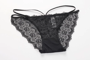 Detailed view of black floral lace underwear with bow accents and sheer mesh fabric