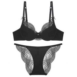 Flat lay of a black lace French style lingerie set with floral patterns and bow details