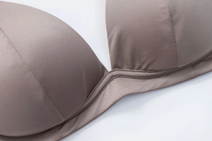 Close-up of seamless dark coffee triangle bra featuring smooth satin finish and fine stitching