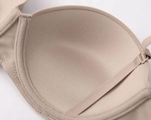 Close-up of the seamless nude bra interior showing smooth integrated cups and fine edge stitching