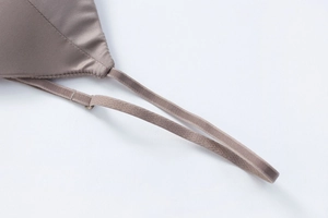 Close-up of adjustable straps and silk-like fabric on this deep brown lace-free bra
