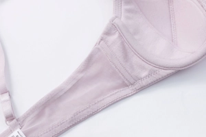 Detail of breathable lavender lace bra showing inner cup padding and fine mesh side wings