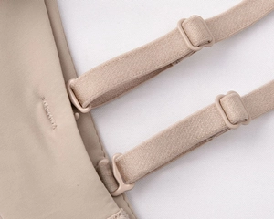 Macro shot of adjustable elastic straps and plastic buckles on seamless nude bra set