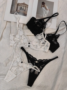 Detail shot of sheer floral embroidery lace lingerie set with delicate buttons and fabric texture