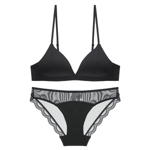 Detailed flat lay of black lace lingerie set featuring seamless triangle bra and briefs