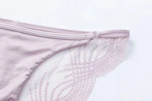 Macro detail of lavender lace stitching and adjustable elastic band on women lingerie