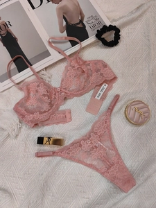 Close-up of pink mesh lace lingerie set with floral embroidery and button detail