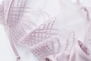 Detailed close-up of lavender lace fabric with breathable mesh and fine elastic strap