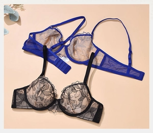 Flat lay of ultra-thin sheer lace bras in black and royal blue with floral embroidery