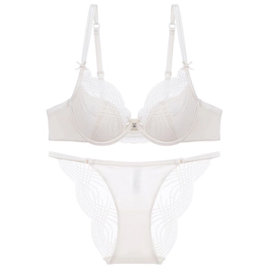 Elegant cream lace lingerie set with scalloped floral patterns and bow detail