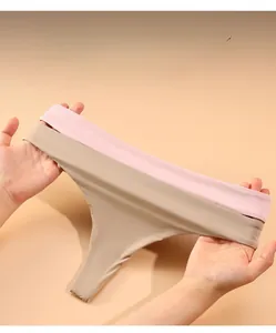 Detail showing the high elasticity of seamless thong panties in pink and beige