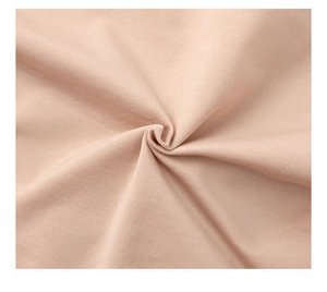 Close-up of seamless light pink fabric showing fine twill weaving and soft texture