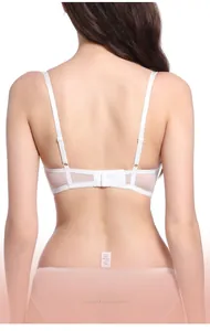 Detail of white lace bra featuring adjustable thin straps and 3-row hook-and-eye back closure