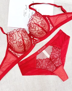 Detail of red rose embroidery and mesh on a lace bra set with Elegant lettering