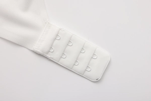 Detailed close-up of the adjustable four-row back hook and eye closure on white lace bra