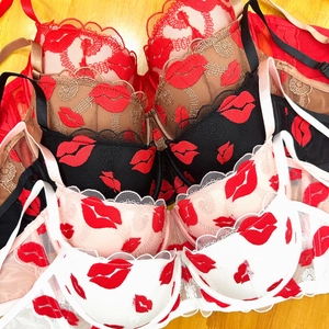 Lace embroidery bra set with red lip pattern in five colors on light wood floor