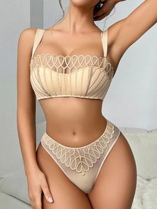Dettaglio del set lingerie in rete con ricamo geometrico e coppe a righe verticali