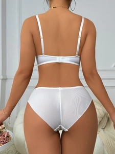 Detail view of the back closure and adjustable straps on this white lace lingerie set