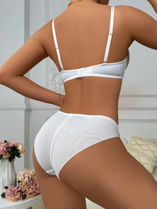 Rear view of white seamless lingerie set featuring breathable mesh back panty and thin straps