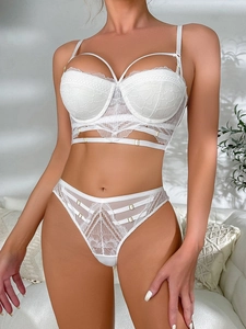 Exquisite white lace lingerie set featuring longline bra with strappy details and lace thong