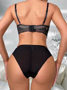 Rear view of black lace lingerie set featuring floral mesh bra and matching sheer panties