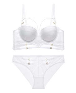 Detailed view of white floral lace lingerie set with mesh details and gold metal buckles